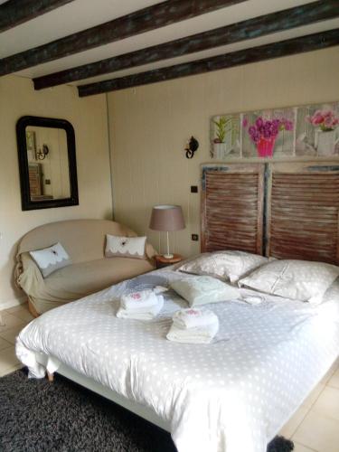 a bedroom with a large bed with towels on it at Domaine du mont scolan in Montgardon