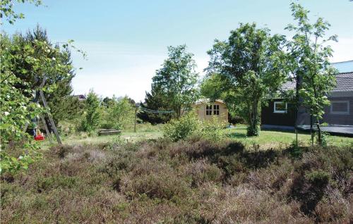 a view of a yard with trees and a house at Holiday Home Kromosevej Rømø Denm in Rømø Kirkeby