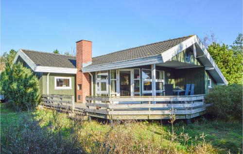 a house with a porch with chairs on it at Holiday Home Kromosevej Rømø Denm in Rømø Kirkeby