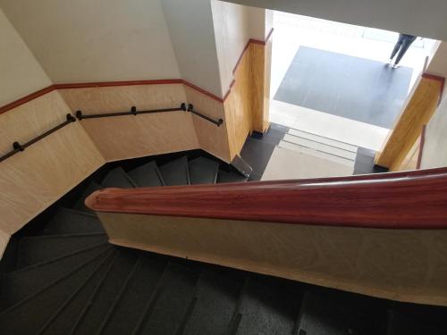 a set of stairs in a building with a wooden at Hotel Gun Glub in Bogotá