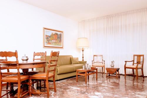 a living room with a couch and a table and chairs at Rosa Garden B&B in Mestre