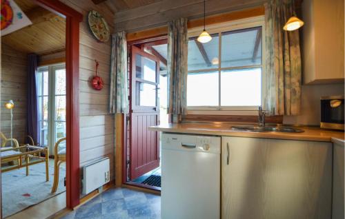 a kitchen with a white refrigerator and a window at Gimle in Bolilmark