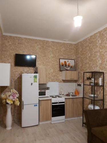 a kitchen with a refrigerator and a stove at Sofija apartamenti in Daugavpils