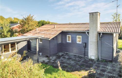 a blue house with a metal roof at Holiday Home Rodbjerg in Aabenraa