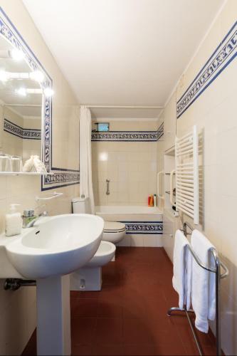 a white bathroom with a sink and a toilet at Villa Le Pergole- Firenze in Florence