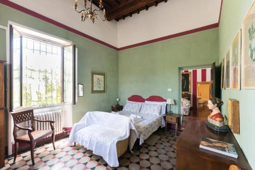 a bedroom with two beds and a table and a window at Villa Le Pergole- Firenze in Florence