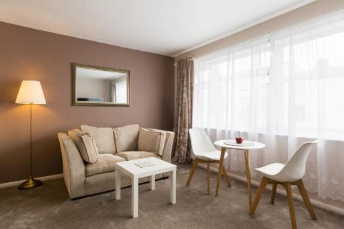 a living room with a couch and a table at Chocolate Nest in Leamington Spa