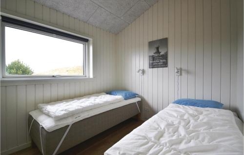 Sønderhoにある3 Bedroom Pet Friendly Home In Fanのベッドと窓が備わる小さな客室です。