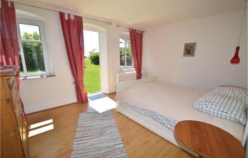 um quarto com uma cama, uma mesa e janelas em 3 Bedroom Gorgeous Home In Harpelunde em Harpelunde