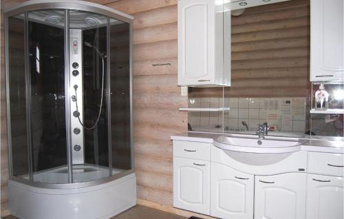 a bathroom with a shower and a sink at Holiday Home Enebærvænget in Humble