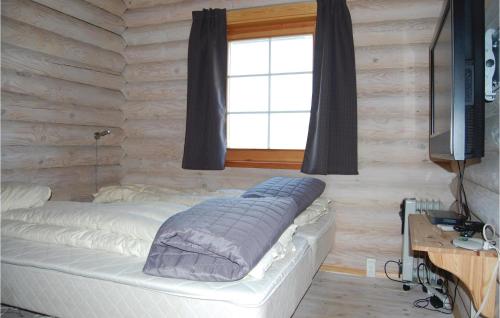a bed in a room with a window at Holiday Home Enebærvænget in Humble