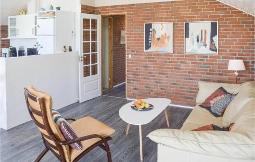 a living room with a couch and a table at Three-Bedroom Holiday Home In Hadsund in Haslevgårde