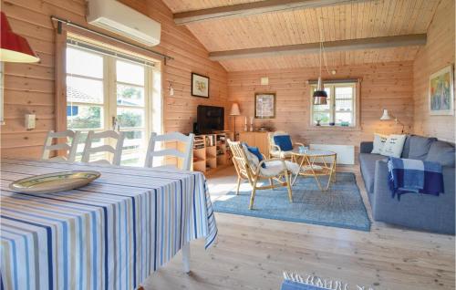 a room with a table and a living room at Two-Bedroom Holiday Home In Nyborg in Nyborg