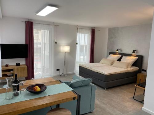 a living room with a bed and a couch at City Apartments Hannover in Hannover