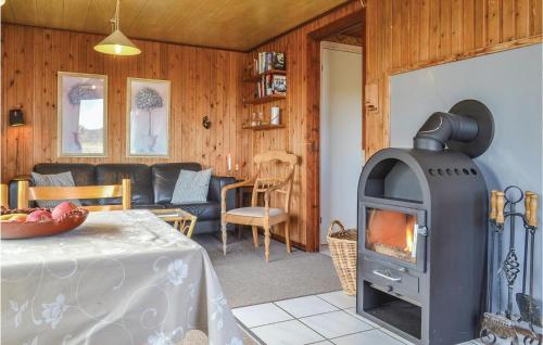 a living room with a wood stove in a room at Holiday Home Arvidvej Denmk Xii in Bjerregård