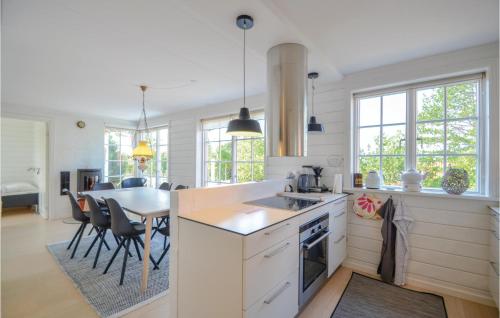 a kitchen and dining room with a table and chairs at Two-Bedroom Holiday Home In Ebeltoft in Ebeltoft