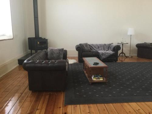 a living room with two couches and a coffee table at Angaston Masonic Lodge in Angaston