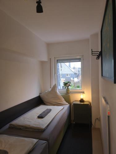 a small bedroom with a bed and a window at NiJole Apartment in Winterberg