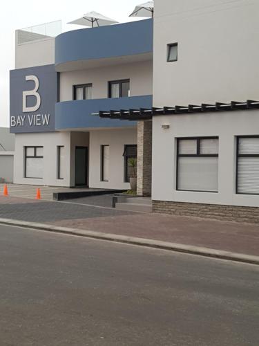 a large white building with a bay view sign on it at Bayview Suites, Unit 9, Room # 13 in Langstrand