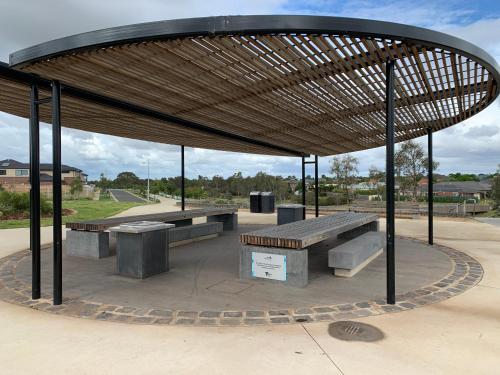 a picnic shelter with benches in a park at Holiday Rental 6 KING BD 12PPL in Truganina
