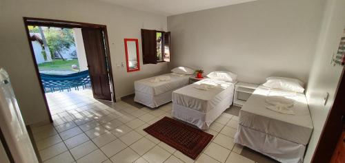 En eller flere senger på et rom på Pousada das Oliveiras