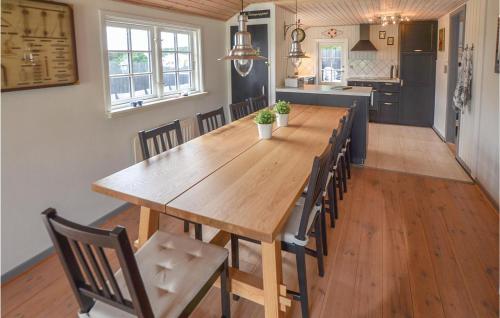 a dining room with a large wooden table and chairs at Holiday Home Nyborg With Fireplace Xiv in Nyborg