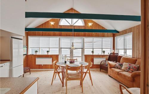 a kitchen and living room with a table and a couch at Holiday Home Ny Bamsestræde O-624 in Otterup