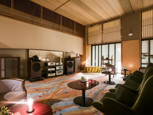 a living room with couches and a table at Hanamomiji in Jozankei