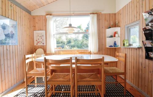 a dining room with a table and chairs at Three-Bedroom Holiday Home In Humble in Humble