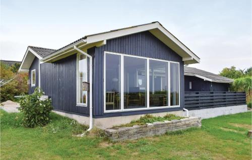 a house with a large window on the side of it at Three-Bedroom Holiday Home In Knebel in Knebel