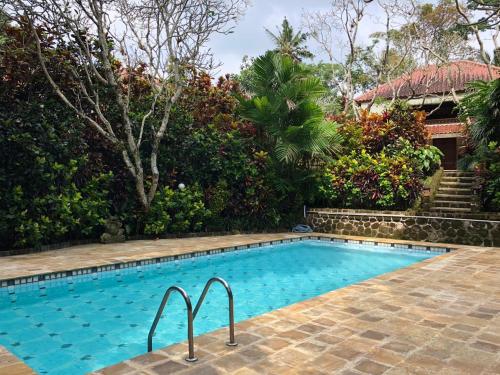 uma piscina em frente a uma casa em Rumah Ganesha Ubud em Ubud