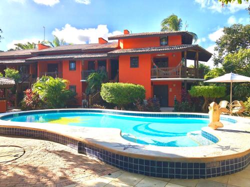 une piscine devant une maison dans l'établissement Vilarejo Do Farol, Praia do Forte, à Praia do Forte
