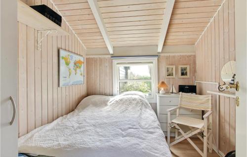 a bedroom with a bed and a desk and a window at Holiday Home Østparken P-625 in Otterup
