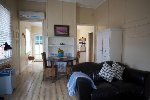 a living room with a couch and a table at Healesville Apartments in Healesville