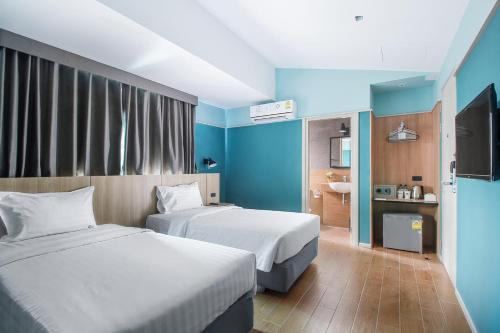 En eller flere senge i et værelse på Mybed Chonburi
