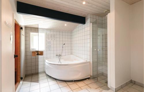 a white tub in a bathroom with a window at Duen in Vester Sømarken