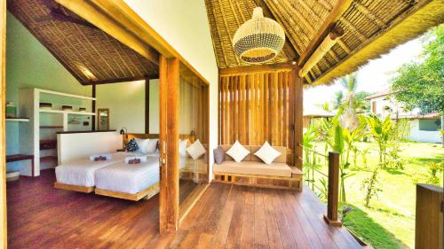 a bedroom with a bed and a balcony at Segara Lombok Beach Resort in Selong Belanak