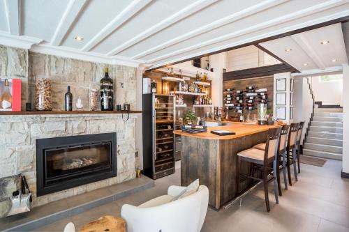 a bar in a room with a fireplace at Head over Hills in Knysna