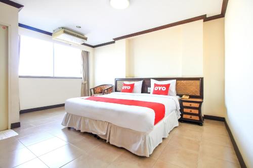 A bed or beds in a room at OYO 383 White Inn Hotel