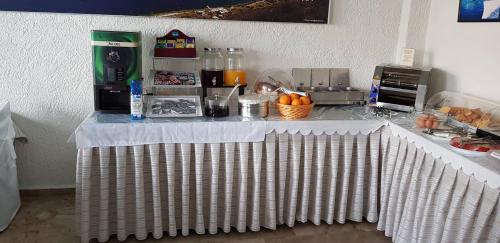a table with a white table cloth on it at Hotel Philoxenia in Masouri