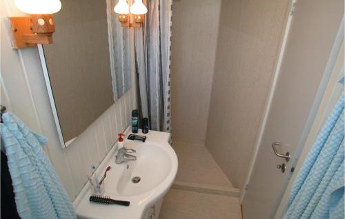 a small bathroom with a sink and a mirror at Mindegrden in Hejls