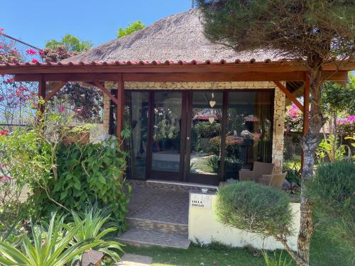 a small house with a thatched roof at Villa Anjing in Nusa Dua