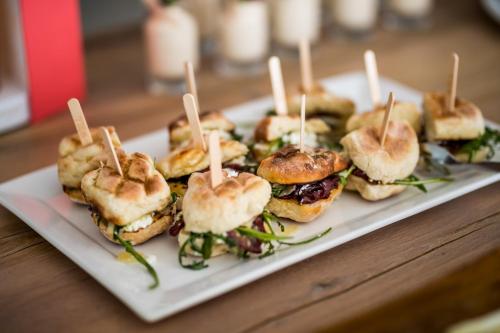 a plate of sandwiches with wooden sticks in them at Head over Hills in Knysna