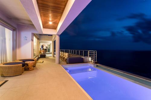 a swimming pool in the middle of a house at Head over Hills in Knysna