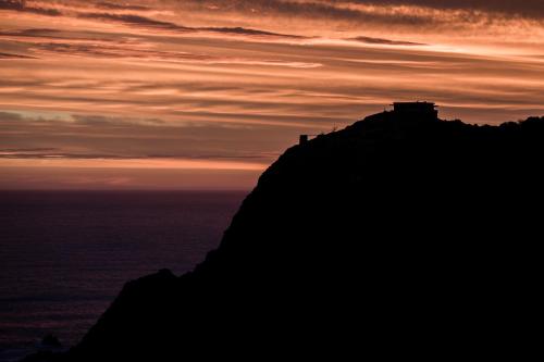 a silhouette of a mountain against a sunset at Head over Hills in Knysna