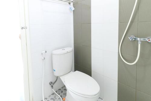 a bathroom with a toilet and a shower at Griya Mulya near Alun Alun Batu Mitra RedDoorz in Batu
