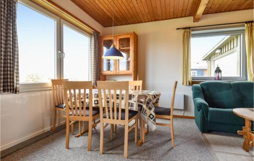 a kitchen and dining room with a table and chairs at Vejlgaard in Nørre Lyngvig