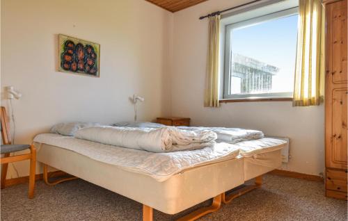 a bed in a room with a window at Vejlgaard in Nørre Lyngvig