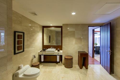 a bathroom with a toilet and a sink at Le Grande Bali in Uluwatu