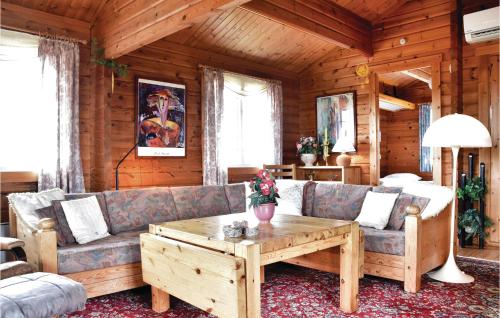 a living room with a couch and a coffee table at Holiday Home Fladsbjergvej Ringkøbing Ii in Klegod